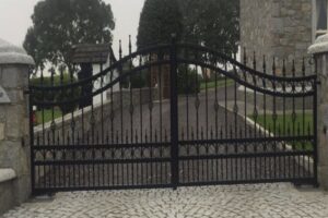 ornate steel gate with arrows and swirls and underground automation