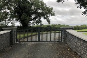 Grey modern style gate - strong vertical bars, grey stonework